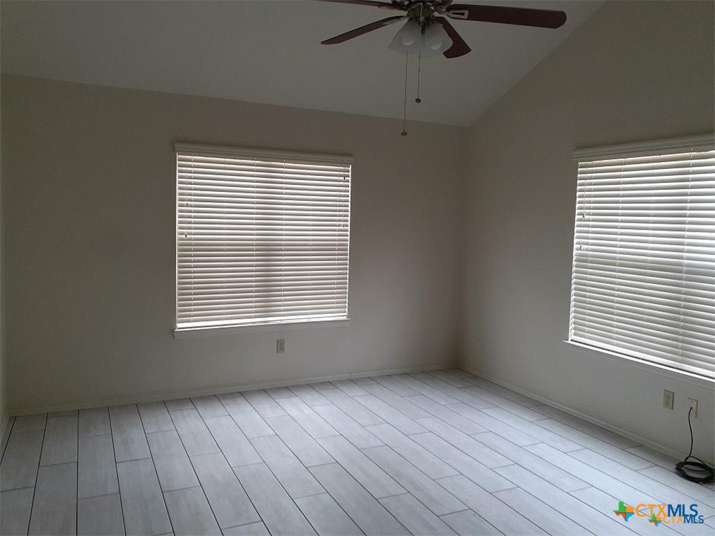 1133 Ashby Street, Unit C9 Seguin, TX 78155 - Photo 13 of 18 a view of an empty room with a window and wooden floor