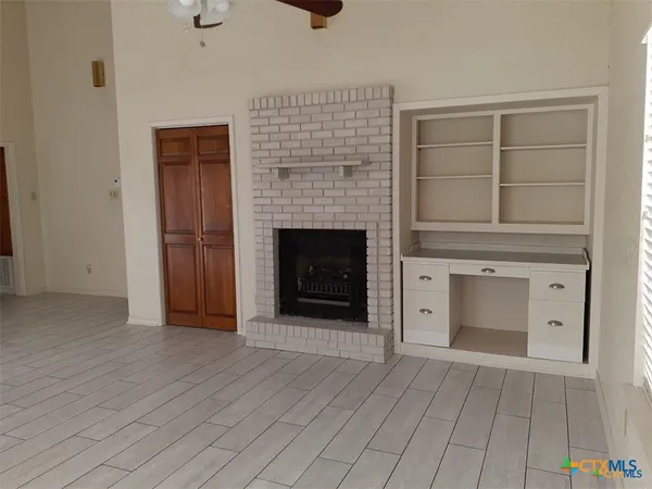 a view of empty room with a fireplace