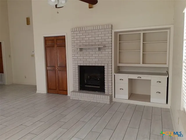 a view of empty room with a fireplace