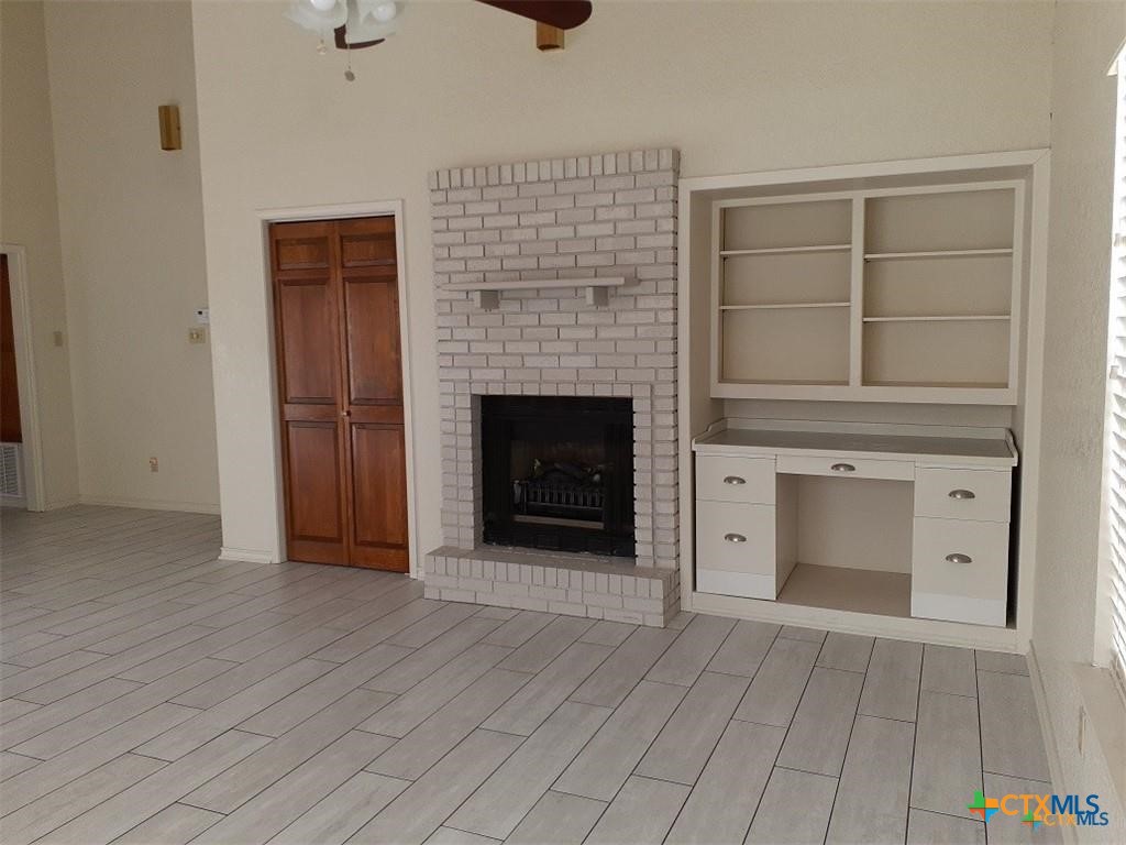 1133 Ashby Street, Unit C9 Seguin, TX 78155 - Photo 2 of 18 an empty room with windows and fireplace