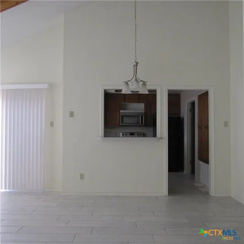 a kitchen with granite countertop cabinets a sink and a stove