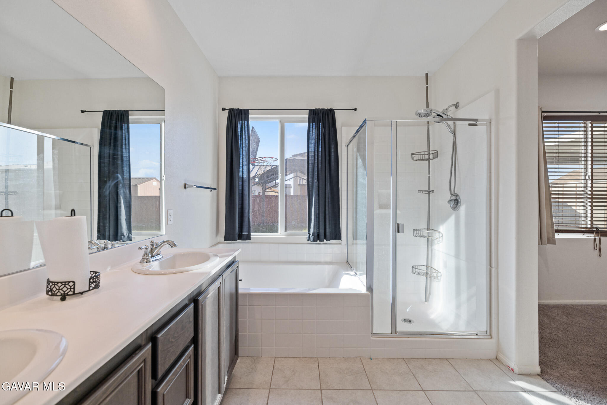 3124 Via Bella Rosa Avenue Rosamond, CA 93560 - Photo 19 of 36 a bathroom with a double vanity sink mirror and shower