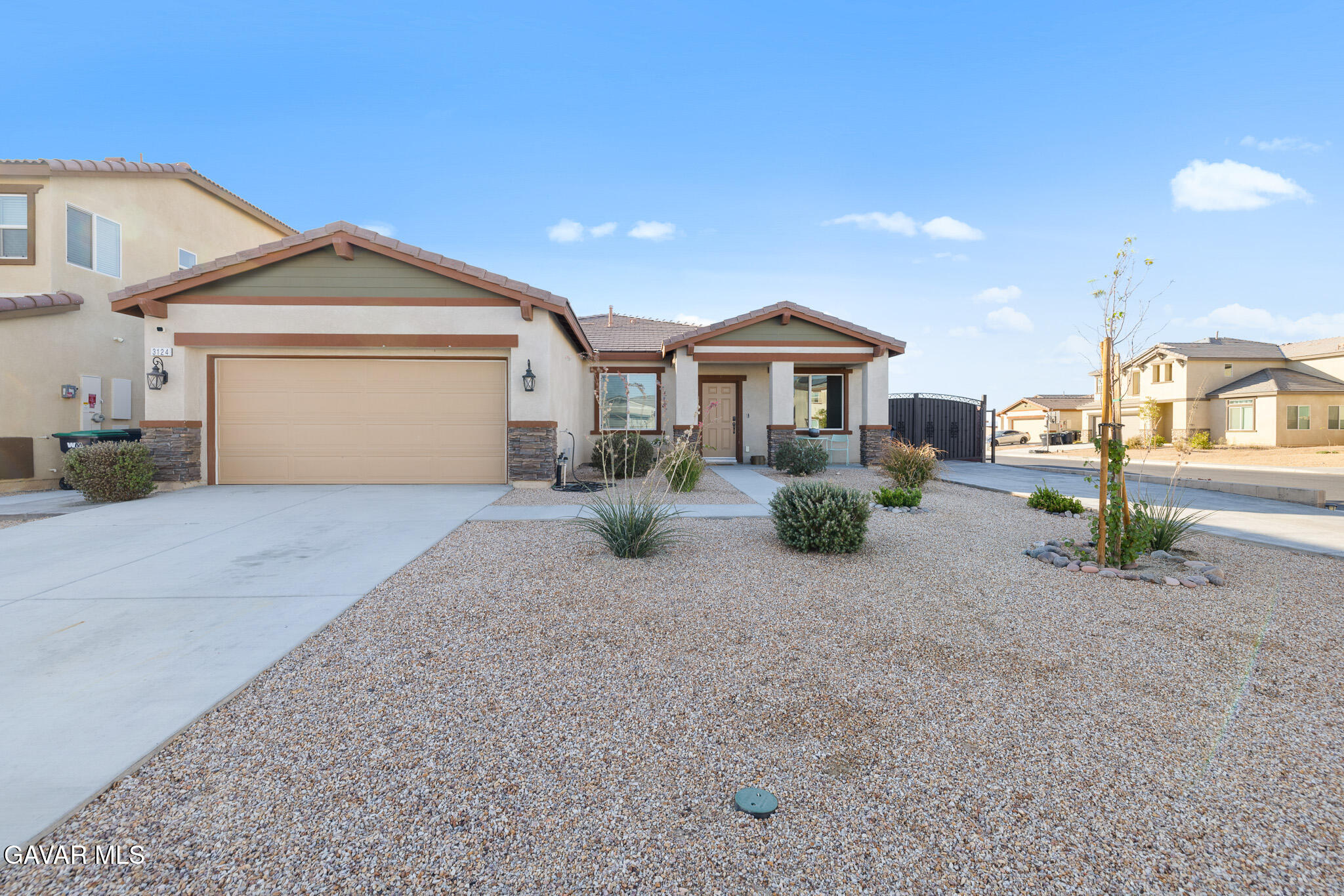 3124 Via Bella Rosa Avenue Rosamond, CA 93560 - Photo 2 of 36 a front view of a house with a yard and garage