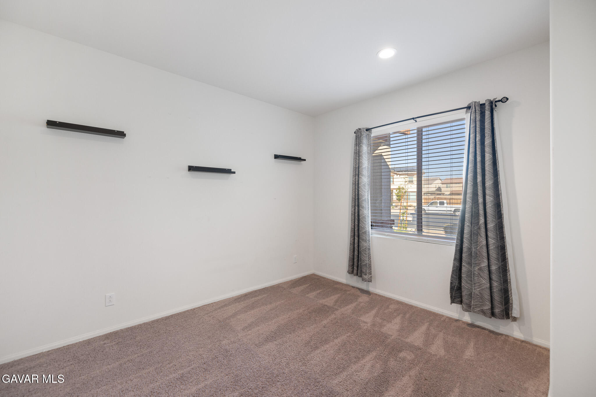 3124 Via Bella Rosa Avenue Rosamond, CA 93560 - Photo 26 of 36 a view of an empty room with a window