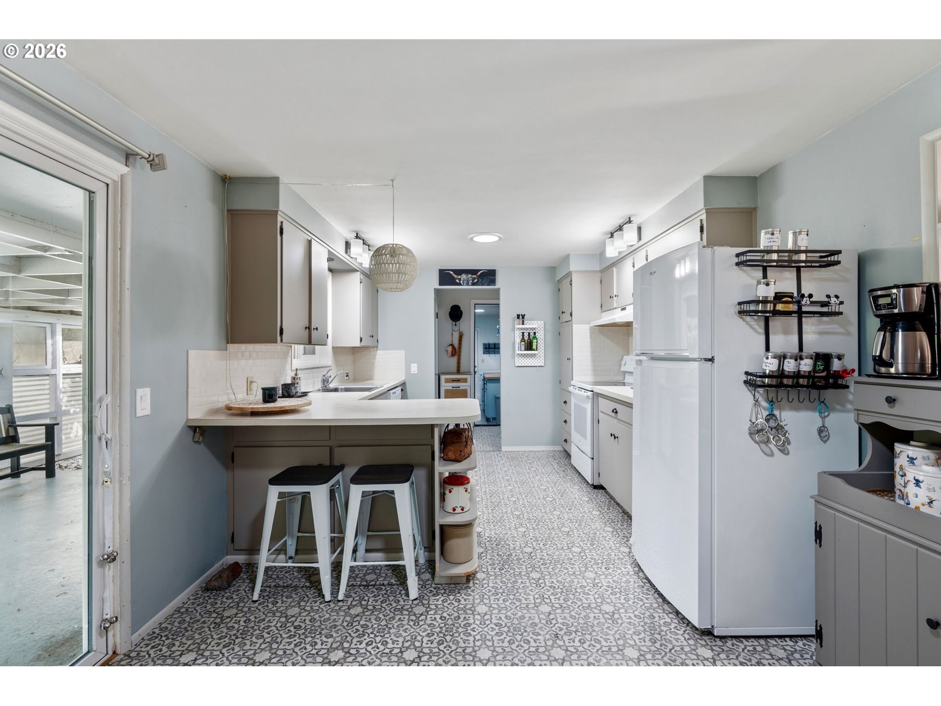 2936 Game Farm Road Springfield, OR 97477 - Photo 10 of 25 a kitchen with refrigerator and chairs