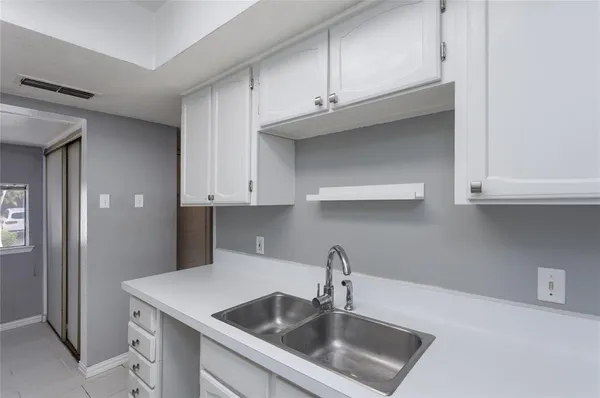 a kitchen with stainless steel appliances granite countertop a sink and cabinets