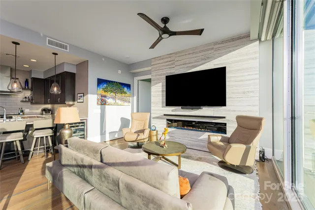 a living room with furniture and a floor to ceiling window