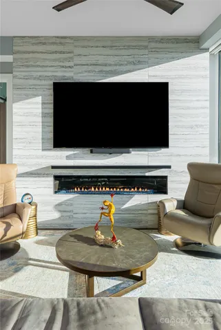 a living room with furniture kitchen and a chandelier