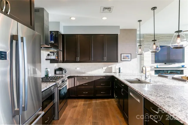 a stove top oven sitting inside of a kitchen