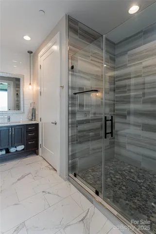 a view of a workspace with bookshelf and a window