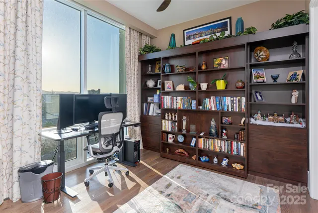 a view of a workspace with furniture and a window