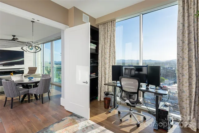 a living room with furniture and floor to ceiling window