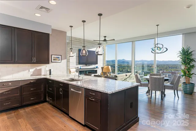 a living room with patio furniture and a potted plant