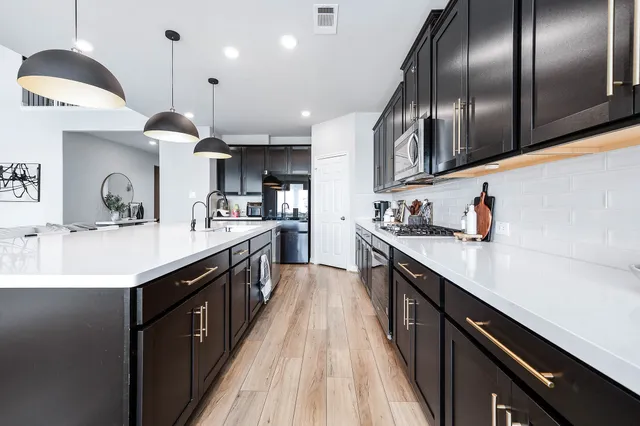 a kitchen with stainless steel appliances granite countertop counter space a sink and cabinets