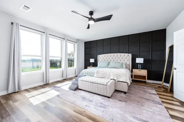 a bedroom with a large bed and a large window