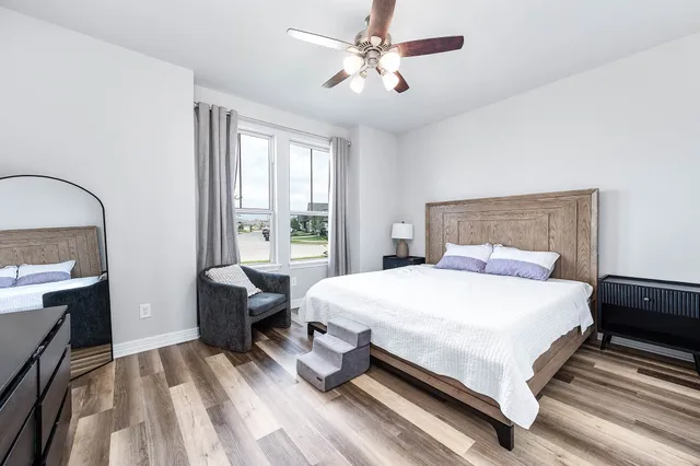 a bedroom with a bed couch and a window