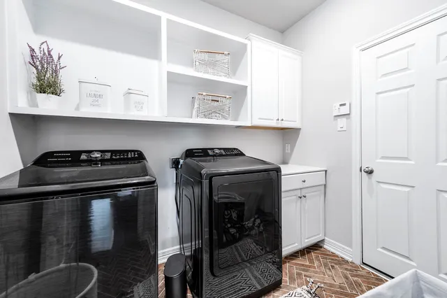 a view of kitchen with stainless steel appliances granite countertop a stove and a refrigerator