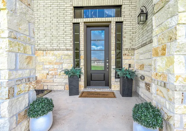 a view of front door of house with potted plant
