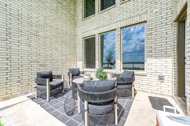a view of a swimming pool with a lawn chairs under palm trees
