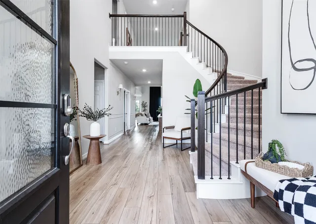 a view of a livingroom with furniture and hardwood floor