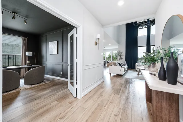 a living room with furniture a large window with wooden floor