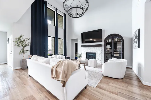 a living room with furniture a fireplace and flat screen tv