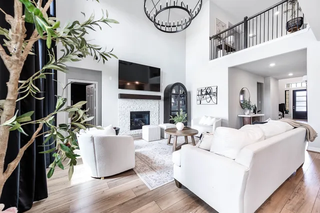 a living room with furniture a fireplace and a flat screen tv