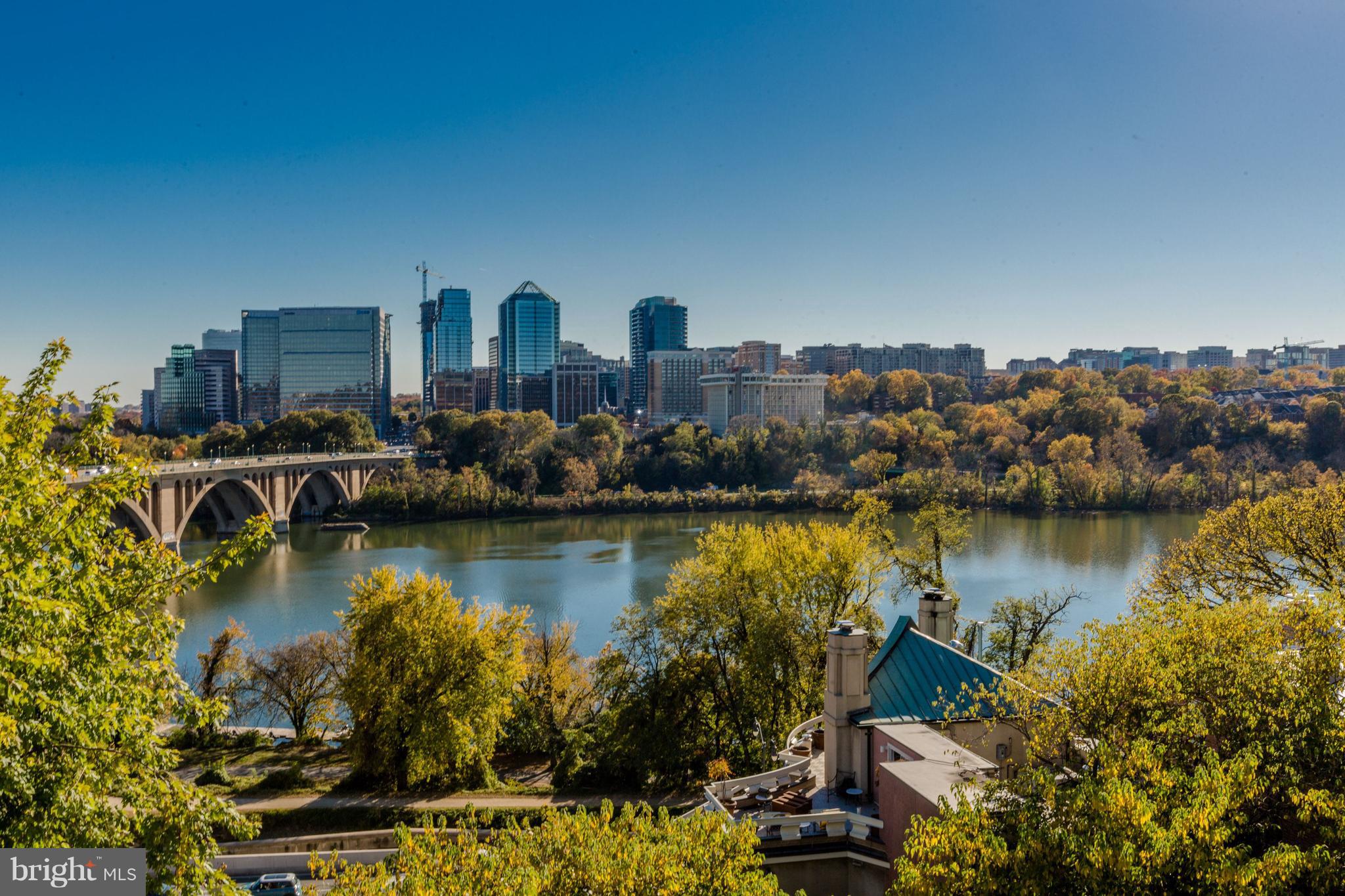 3620 Prospect Street Northwest Washington, DC 20007 - Photo 1 of 23 a view of a lake with boats and trees in the background