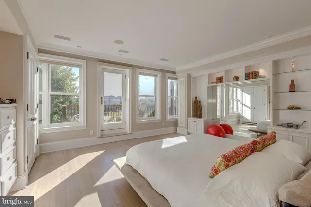 a bed sitting in a bedroom next to a window