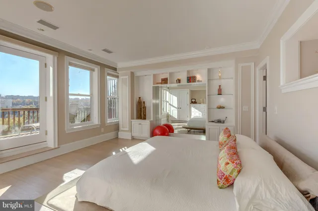 a bedroom with furniture and a large window