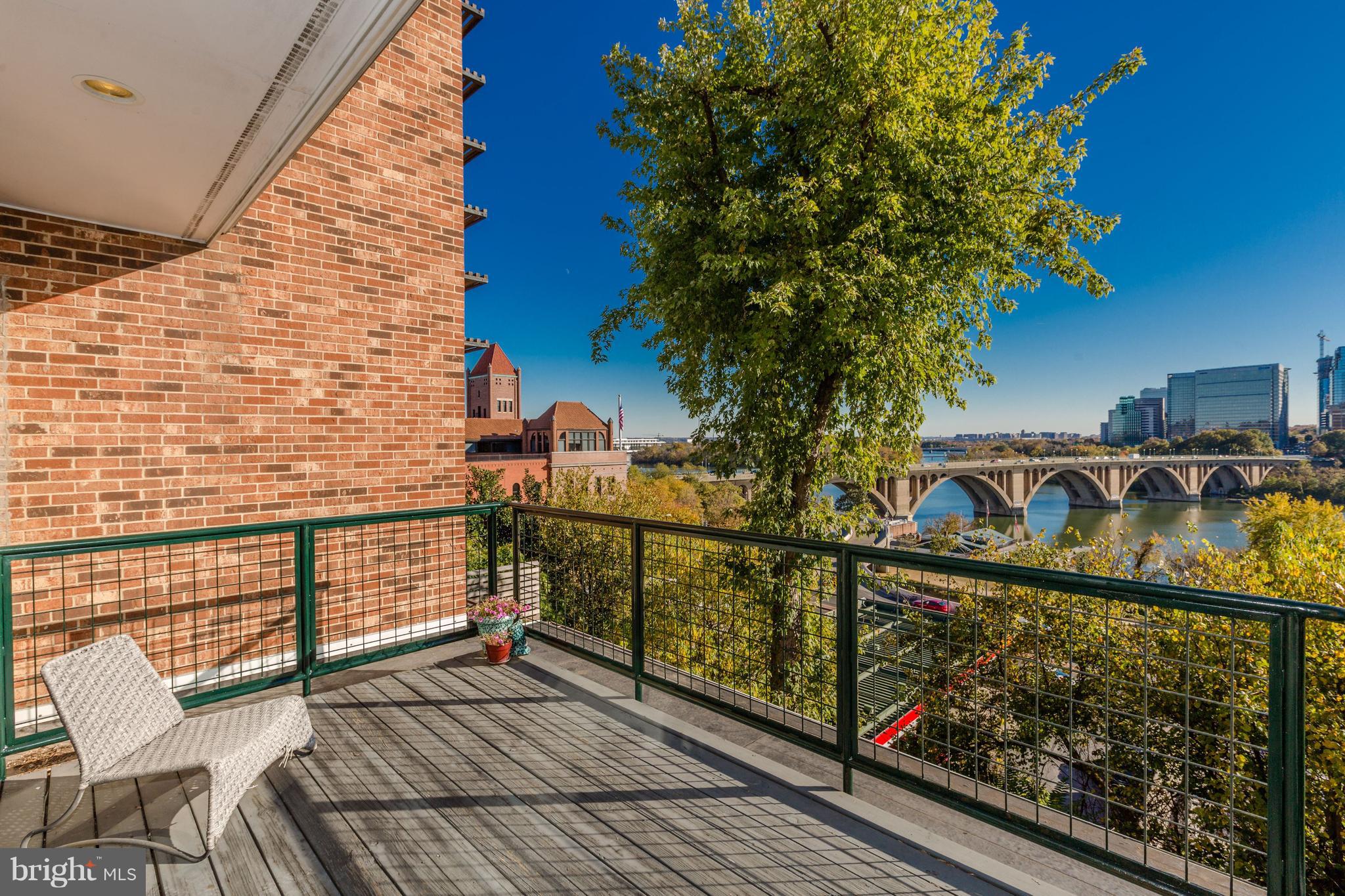 3620 Prospect Street Northwest Washington, DC 20007 - Photo 21 of 23 a view of a balcony with wooden floor and iron fence