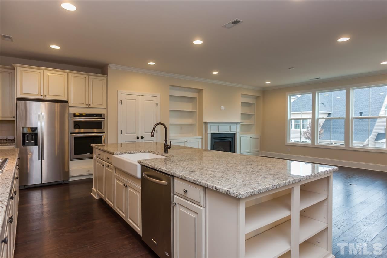 3908 Ivory Rose Lane Raleigh, NC 27612 - Photo 2 of 4 a kitchen with stainless steel appliances granite countertop a sink stove and refrigerator