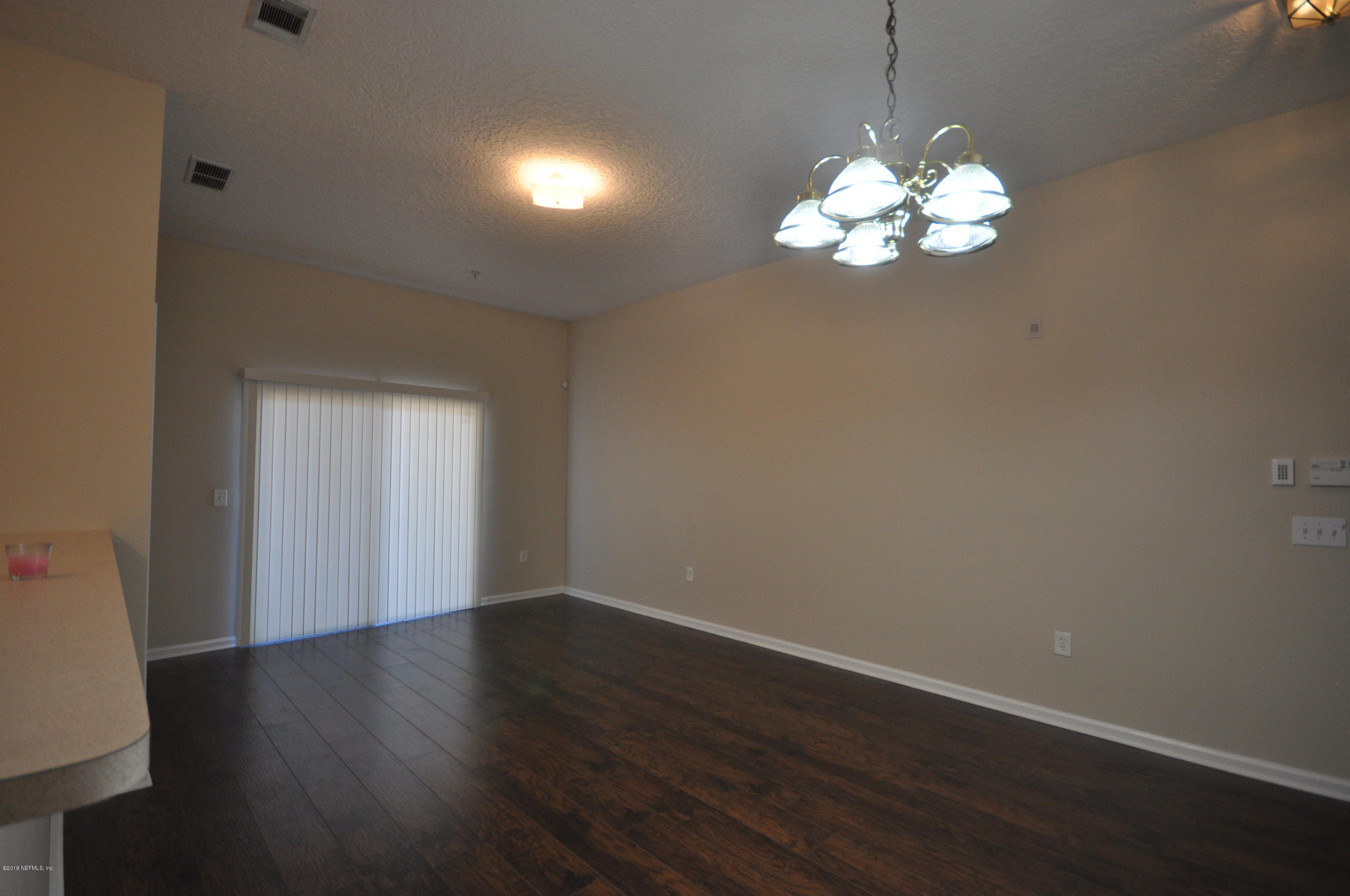 7920 Merrill Road, Unit 1203 Jacksonville, FL 32277 - Photo 3 of 13 a view of a chandelier in a room
