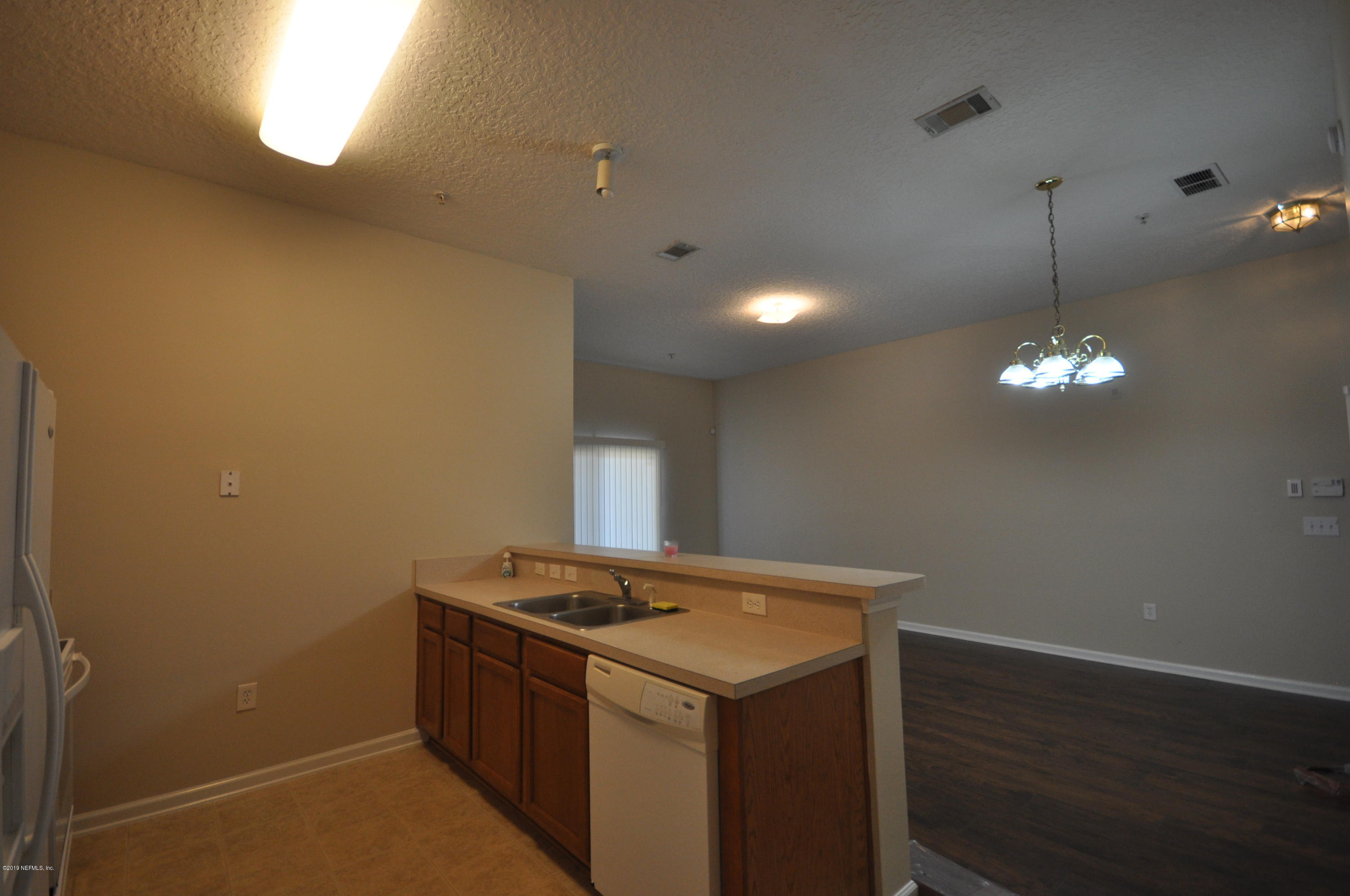 7920 Merrill Road, Unit 1203 Jacksonville, FL 32277 - Photo 9 of 13 a view of a storage and utility room with wooden floor