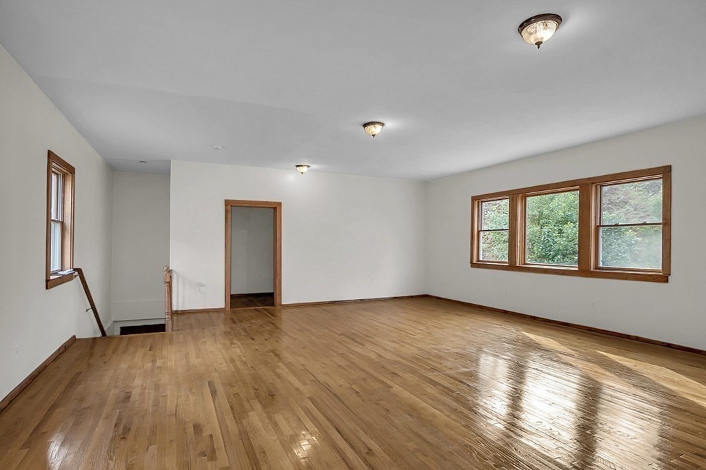 15 Stagecoach Road Topsfield, MA 01983 - Photo 17 of 40 an empty room with wooden floor and windows
