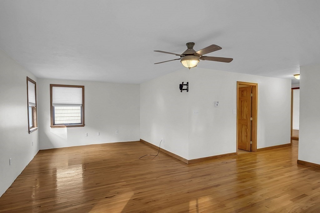 15 Stagecoach Road Topsfield, MA 01983 - Photo 19 of 40 a view of a room with a ceiling fan a hardwood floor and a ceiling fan
