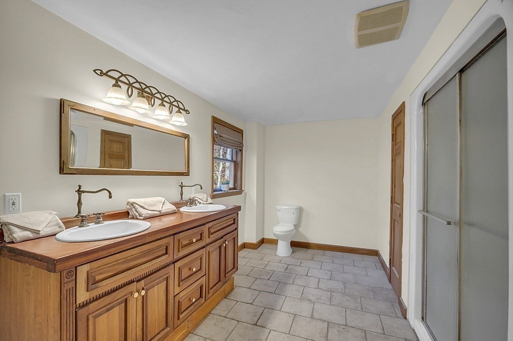 15 Stagecoach Road Topsfield, MA 01983 - Photo 20 of 40 a bathroom with a double vanity sink mirror and toilet