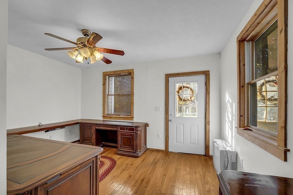 15 Stagecoach Road Topsfield, MA 01983 - Photo 27 of 40 a view of a livingroom with a fireplace a chandelier and wooden floor