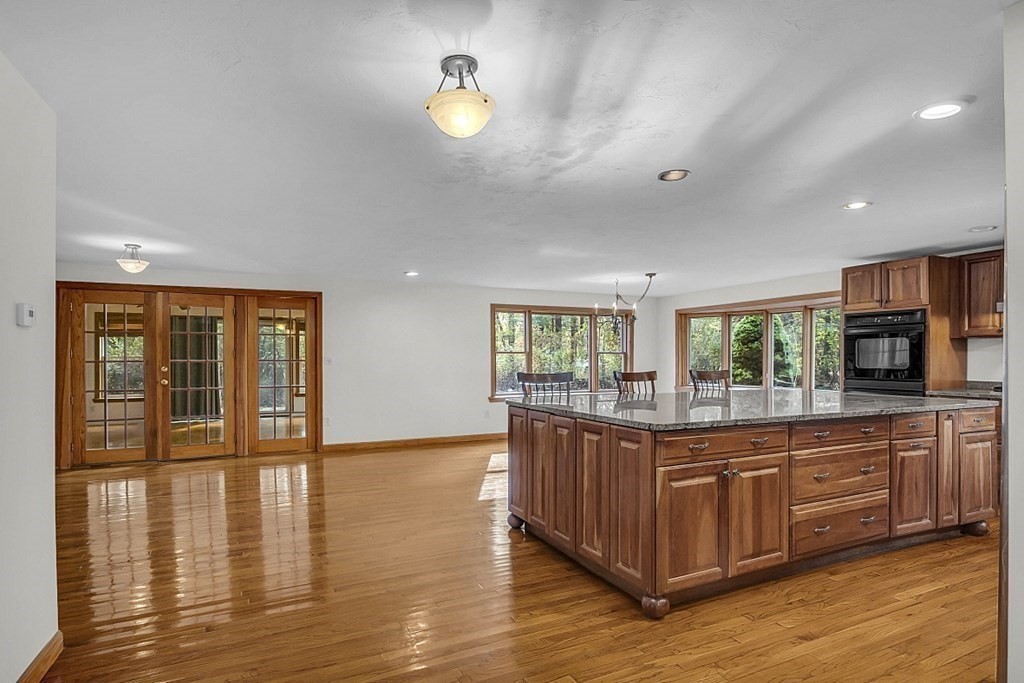 15 Stagecoach Road Topsfield, MA 01983 - Photo 7 of 40 a kitchen with stainless steel appliances granite countertop a stove and a wooden floors