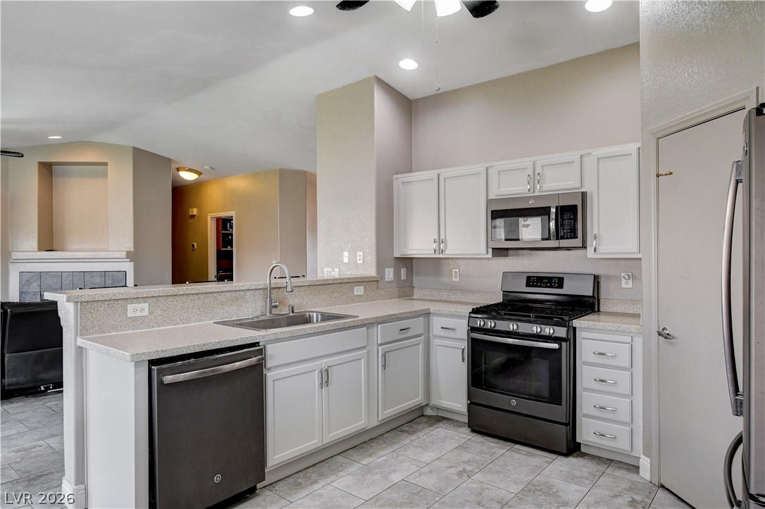 910 Cobblestone Cove Road North Las Vegas, NV 89081 - Photo 9 of 30 A well-appointed kitchen features ample counter space, bright cabinetry, and modern appliances.