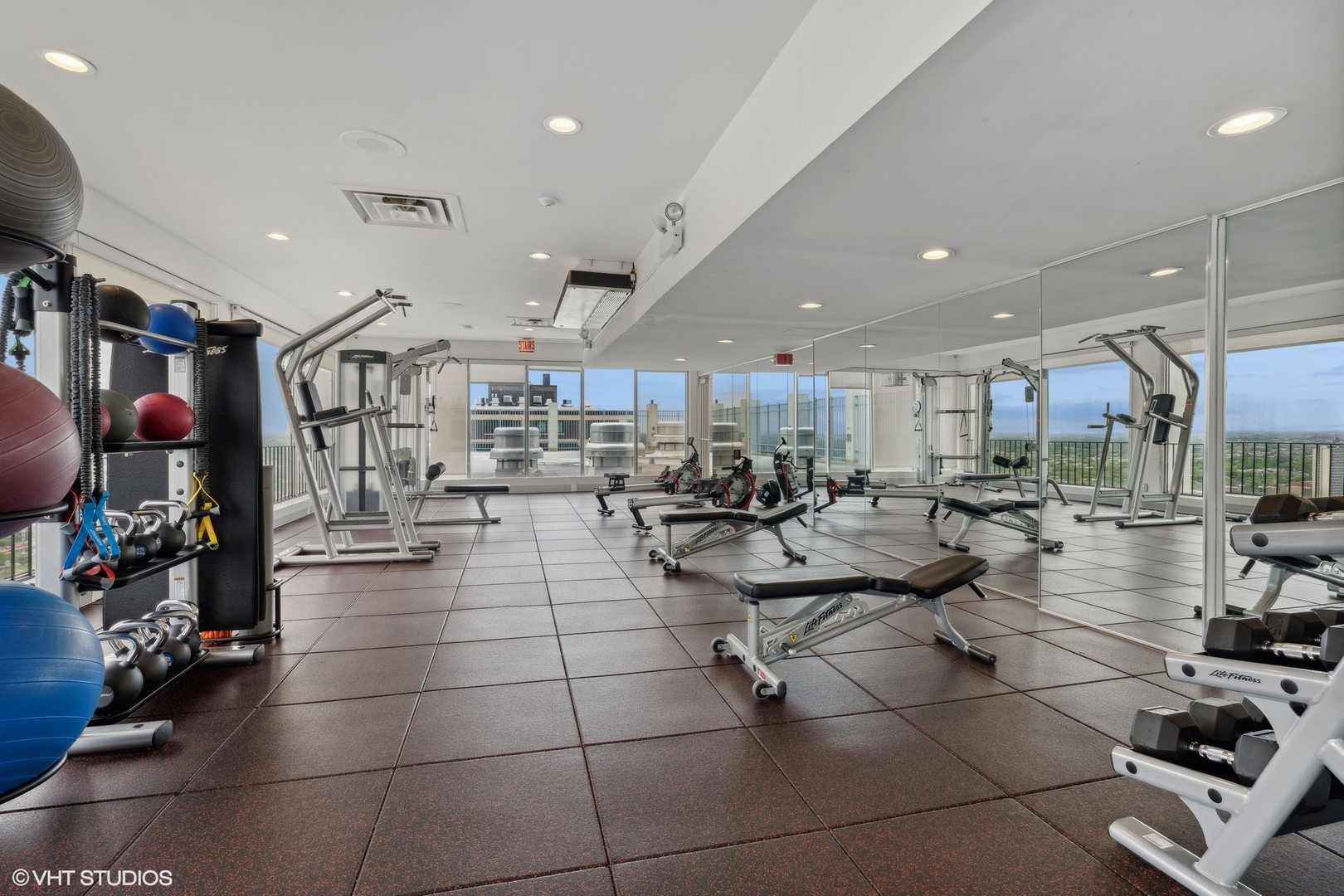 6171 North Sheridan Road, Unit 1112 Chicago, IL 60660 - Photo 17 of 23 a large room with lots of chairs and mirrors