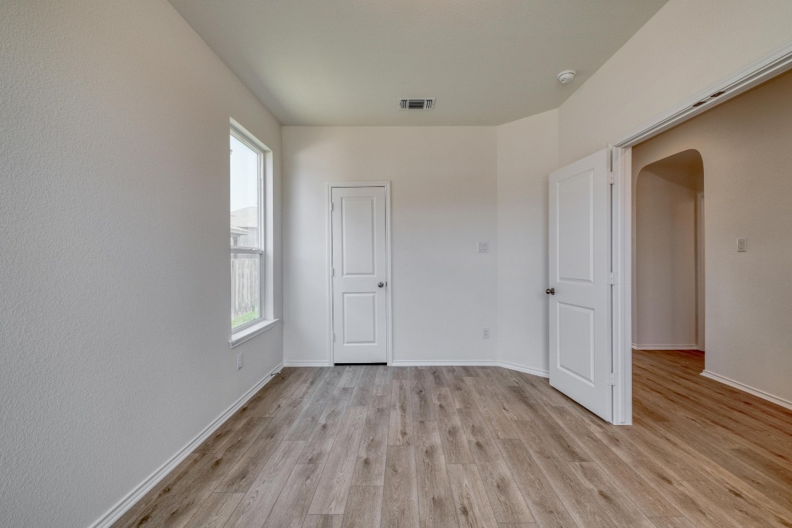 800 Yellow Ribbon Trail Jarrell, TX 76537 - Photo 13 of 32 a view of empty room with wooden floor and fan
