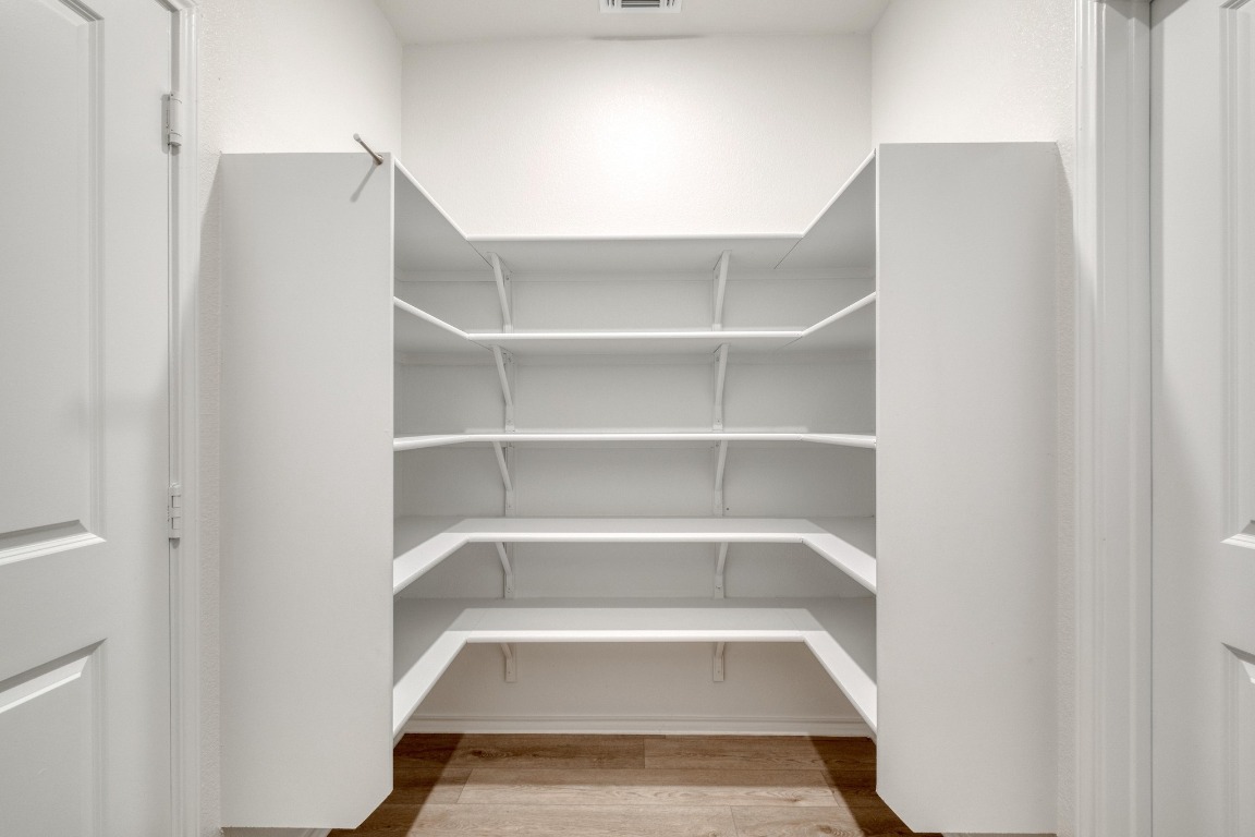800 Yellow Ribbon Trail Jarrell, TX 76537 - Photo 16 of 32 a view of walk in closet with empty racks