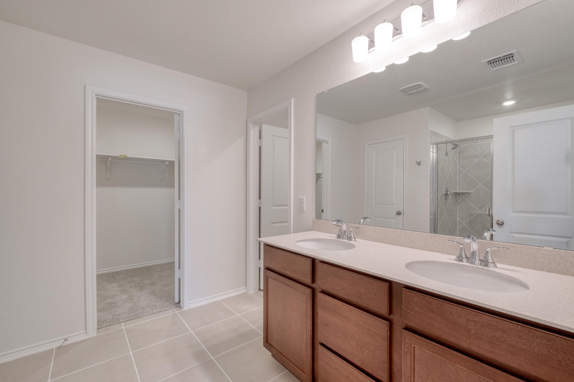 800 Yellow Ribbon Trail Jarrell, TX 76537 - Photo 21 of 32 a bathroom with a sink double vanity and a mirror