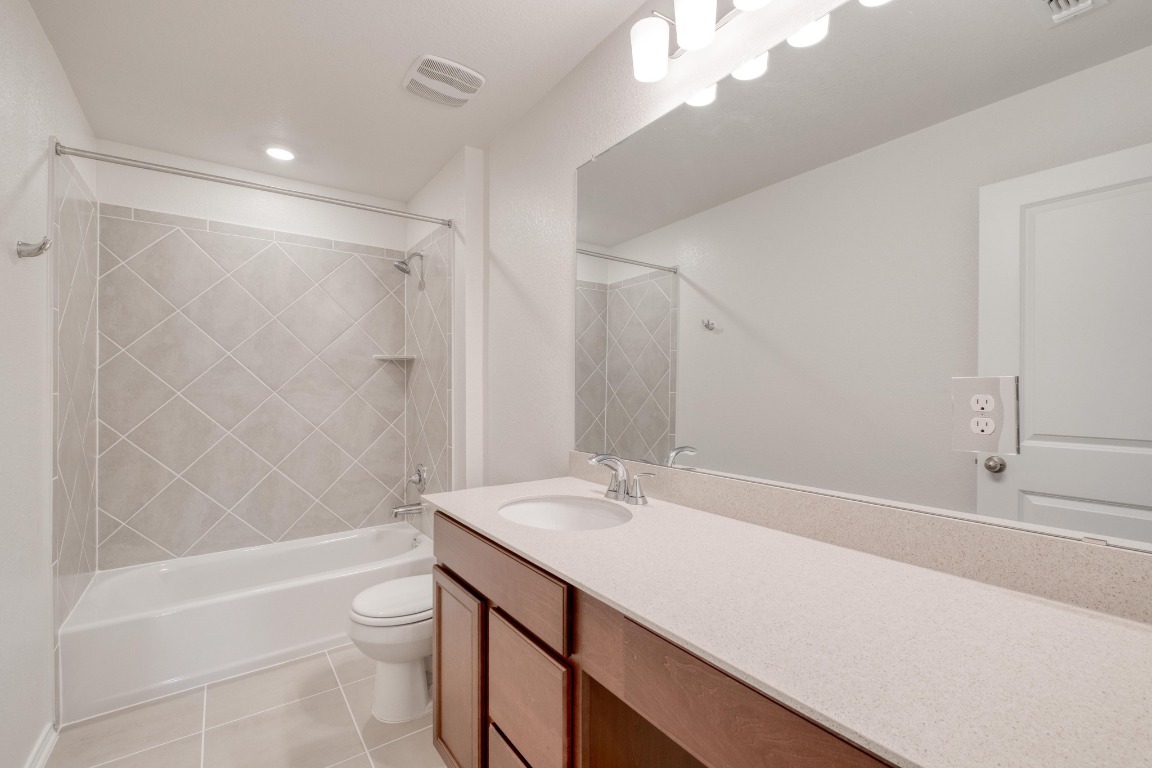 800 Yellow Ribbon Trail Jarrell, TX 76537 - Photo 27 of 32 a bathroom with a sink a toilet and shower