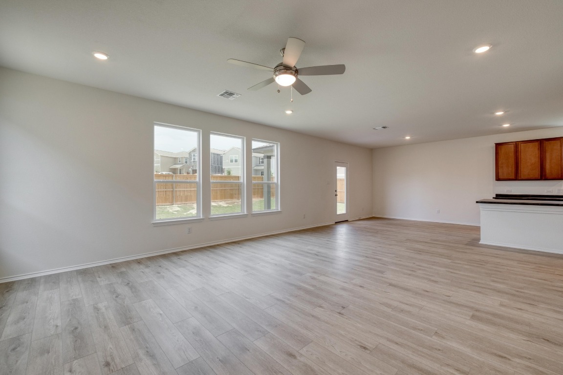 800 Yellow Ribbon Trail Jarrell, TX 76537 - Photo 3 of 32 a view of an empty room with a window and wooden floor