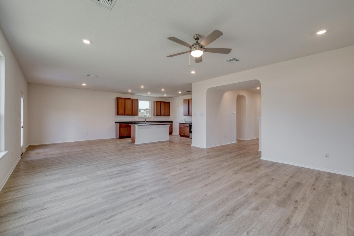 800 Yellow Ribbon Trail Jarrell, TX 76537 - Photo 4 of 32 a view of an empty room with wooden floor and a window