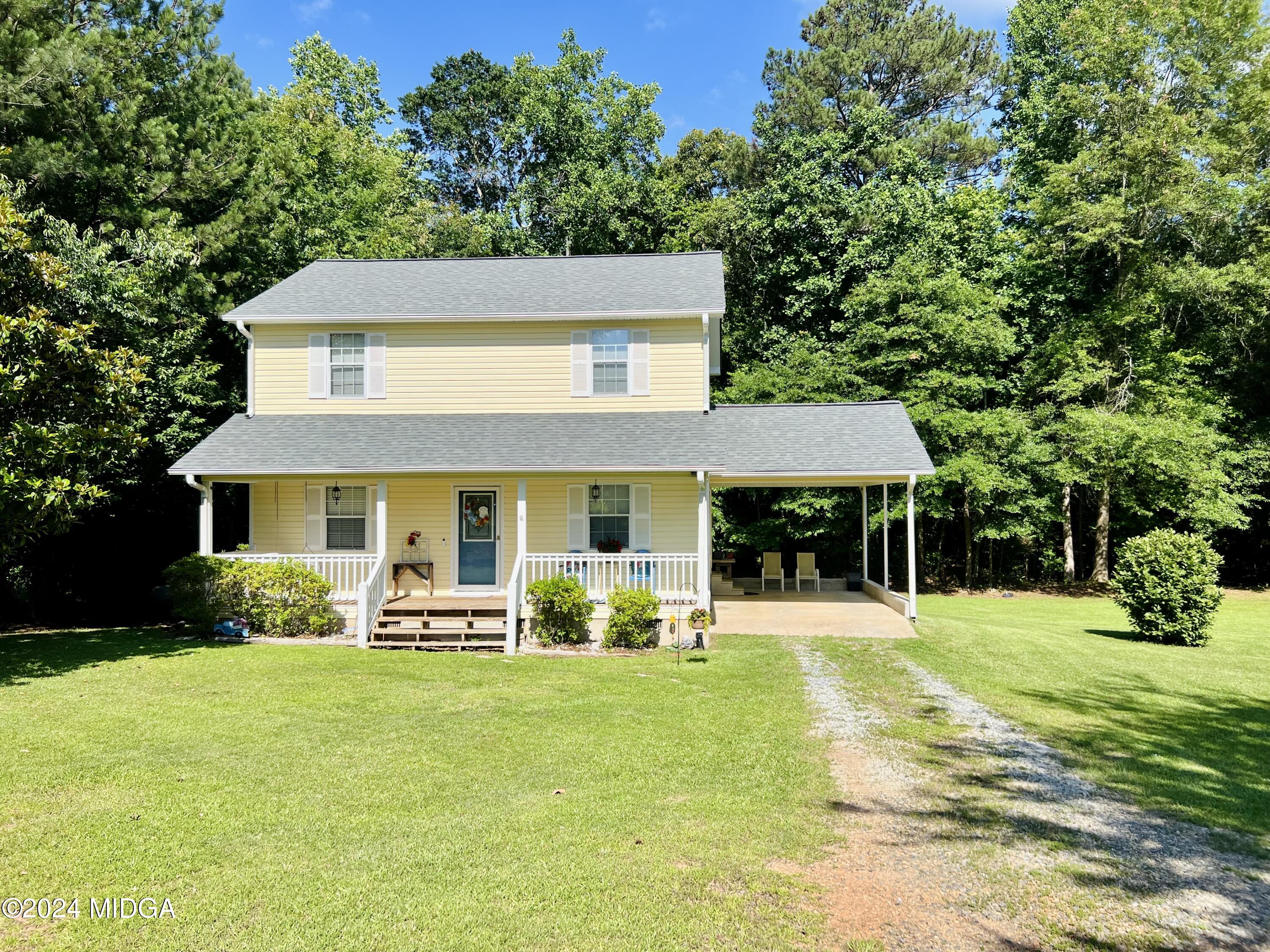 25 Ruby Road Jackson, GA 30233 - Photo 1 of 29 a front view of a house with a yard table and chairs