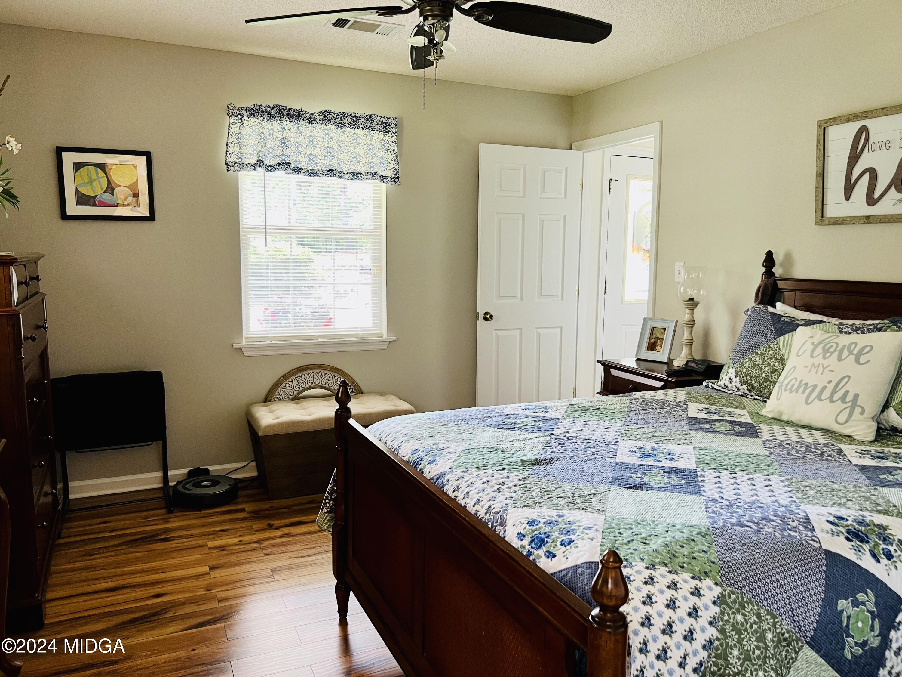 25 Ruby Road Jackson, GA 30233 - Photo 17 of 29 a bedroom with a bed and wooden floor