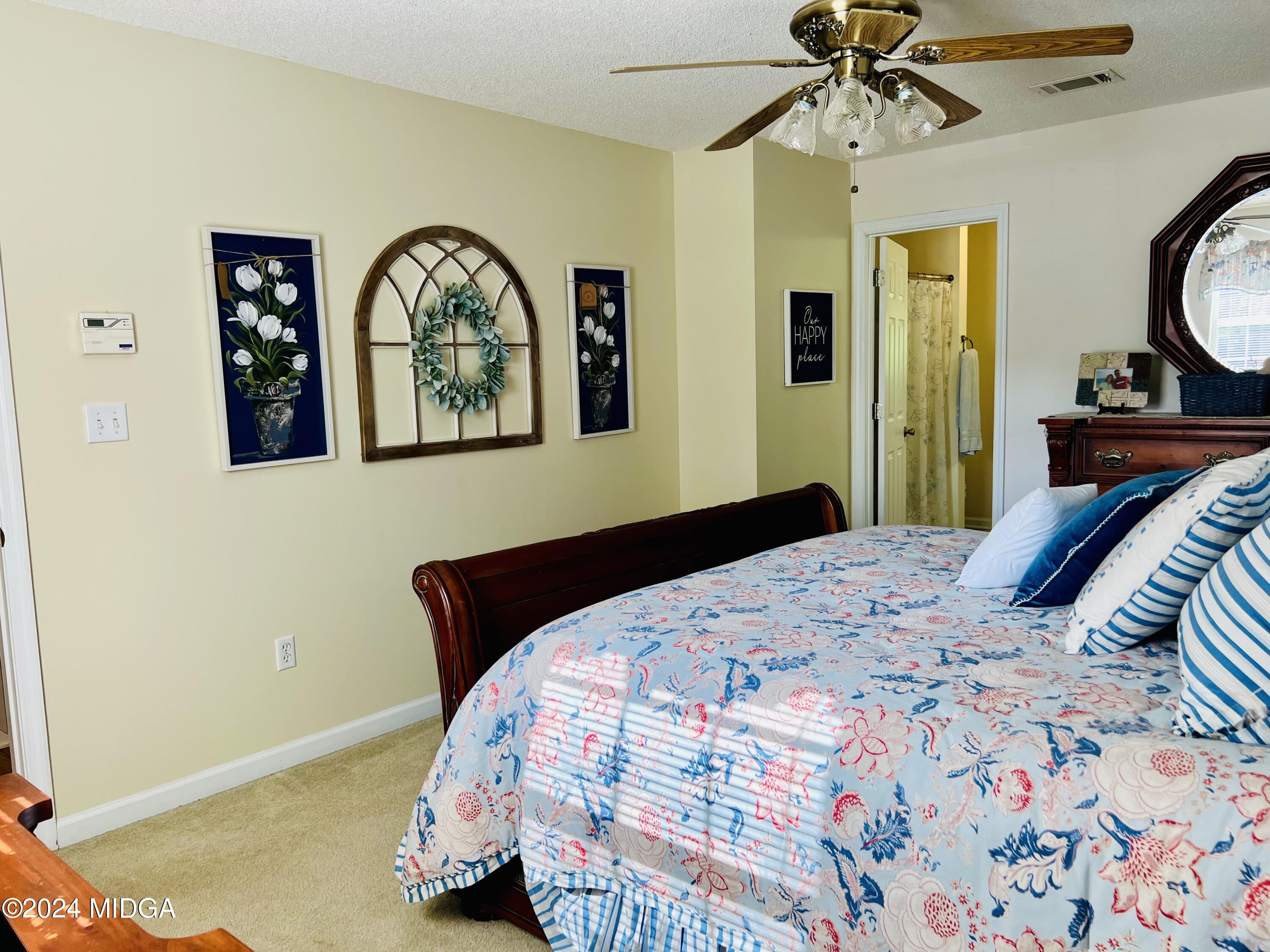25 Ruby Road Jackson, GA 30233 - Photo 19 of 29 a bedroom with a bed and a chandelier